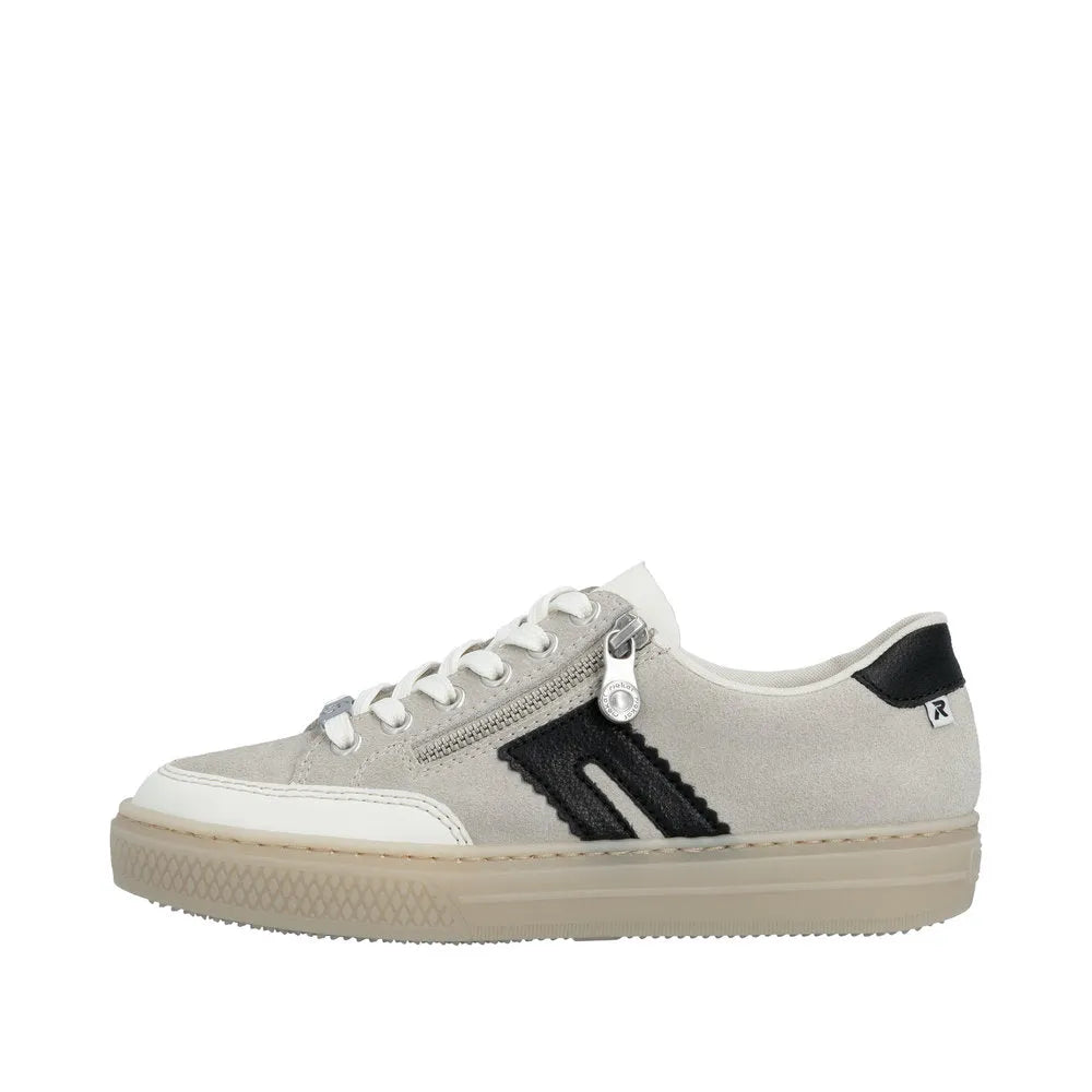 Rieker L5903-40 women's off-white suede sneakers with black accents, lace-up and zip closure, and rubber sole.