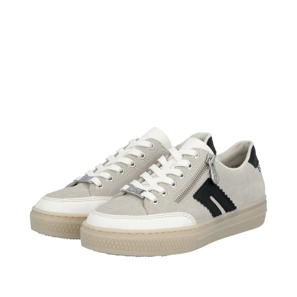 Rieker L5903-40 ladies off-white suede sneakers with lace-up, zipper detail, black accents, and chunky rubber sole.