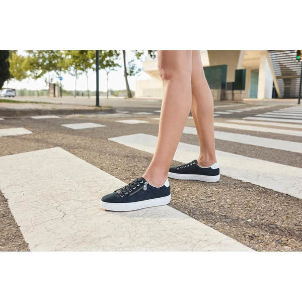 Rieker L59L1-15 navy suede women's casual sneakers with white soles, zip and lace-up closure, outdoor setting.