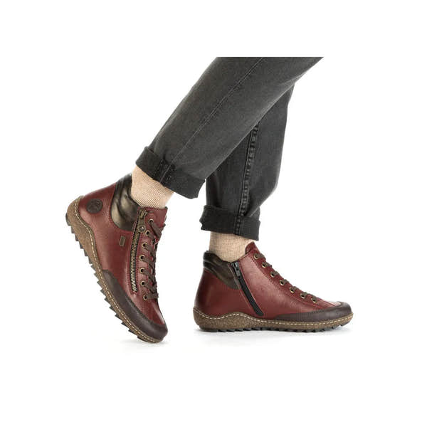 Rieker L7500-35 women's red water-resistant ankle boots with zipper and lace-up closure, cushioned sole, and rugged outsole.