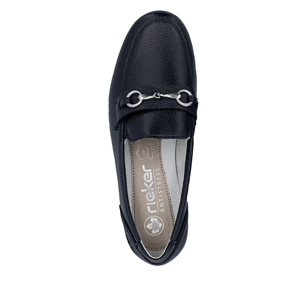 Black leather slip-on shoe with metal horsebit detail, cushioned beige interior with Rieker branding and anti-stress features.