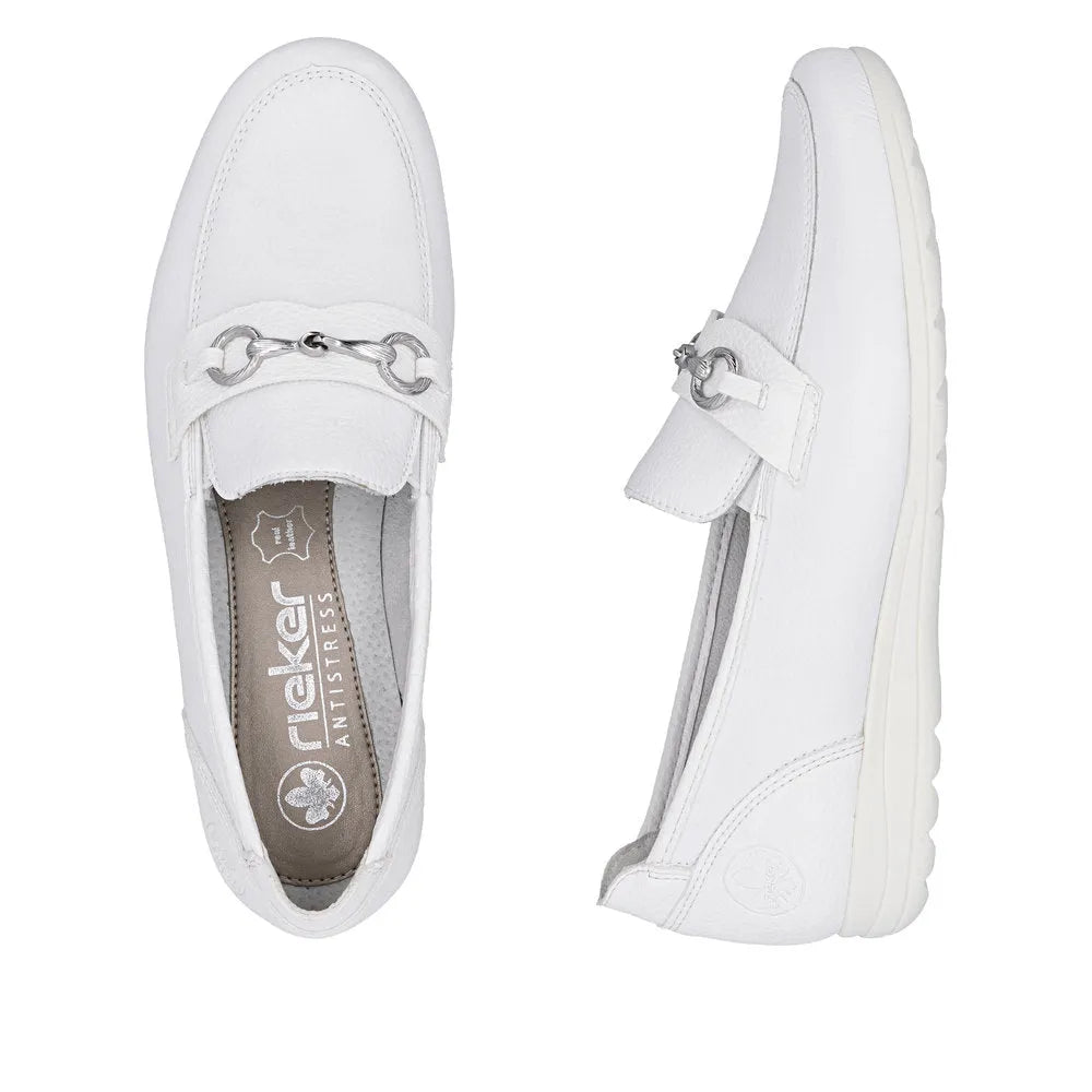 White leather slip-on shoes with silver hardware detail and a textured sole, designed for women's casual wear.