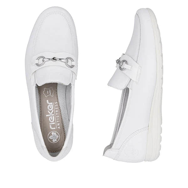 White leather slip-on shoes with silver hardware detail and a textured sole, designed for women's casual wear.