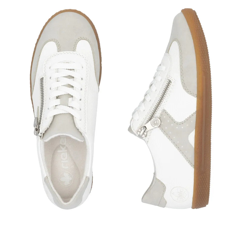 Rieker L9700-80 women's white sneakers with zipper and lace-up front, beige accents, and gum sole.