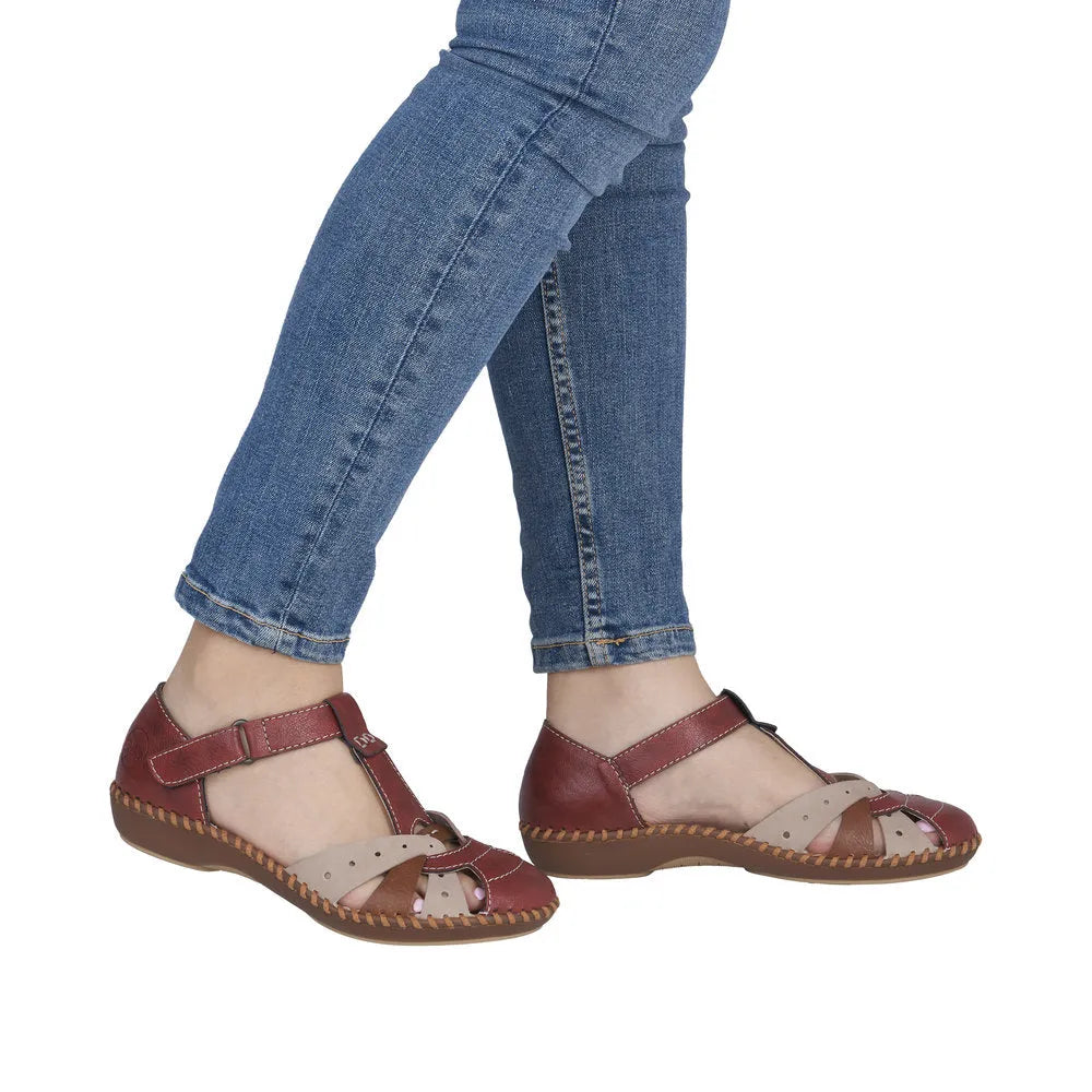 Red leather and beige fabric wide fit sandals with touch fastenings, worn with jeans.