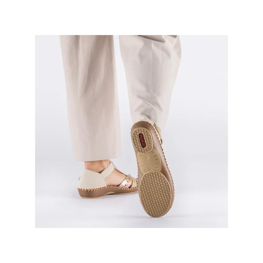 Rieker M1655-62 women's wide beige touch fastening sandals with cushioned sole and open toe, displayed on a model's feet.