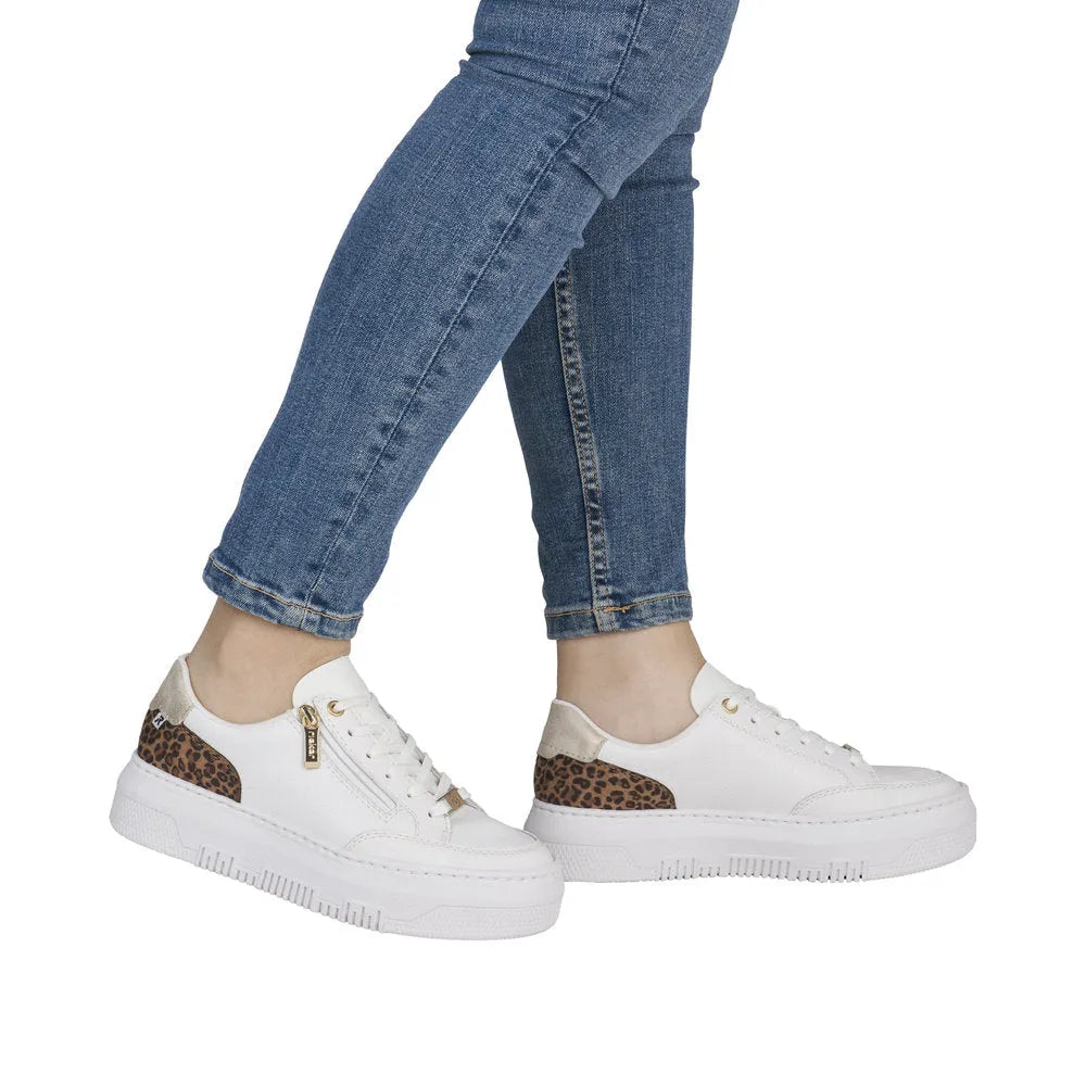 White leather trainers with leopard print accents, zip and lace fastenings, on a white rubber sole.