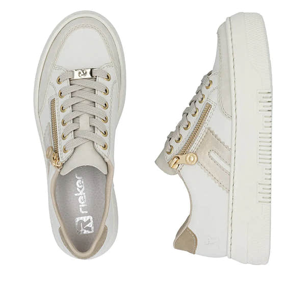 Off-white leather trainers with gold zipper details, lace-up front, and chunky sole for women.