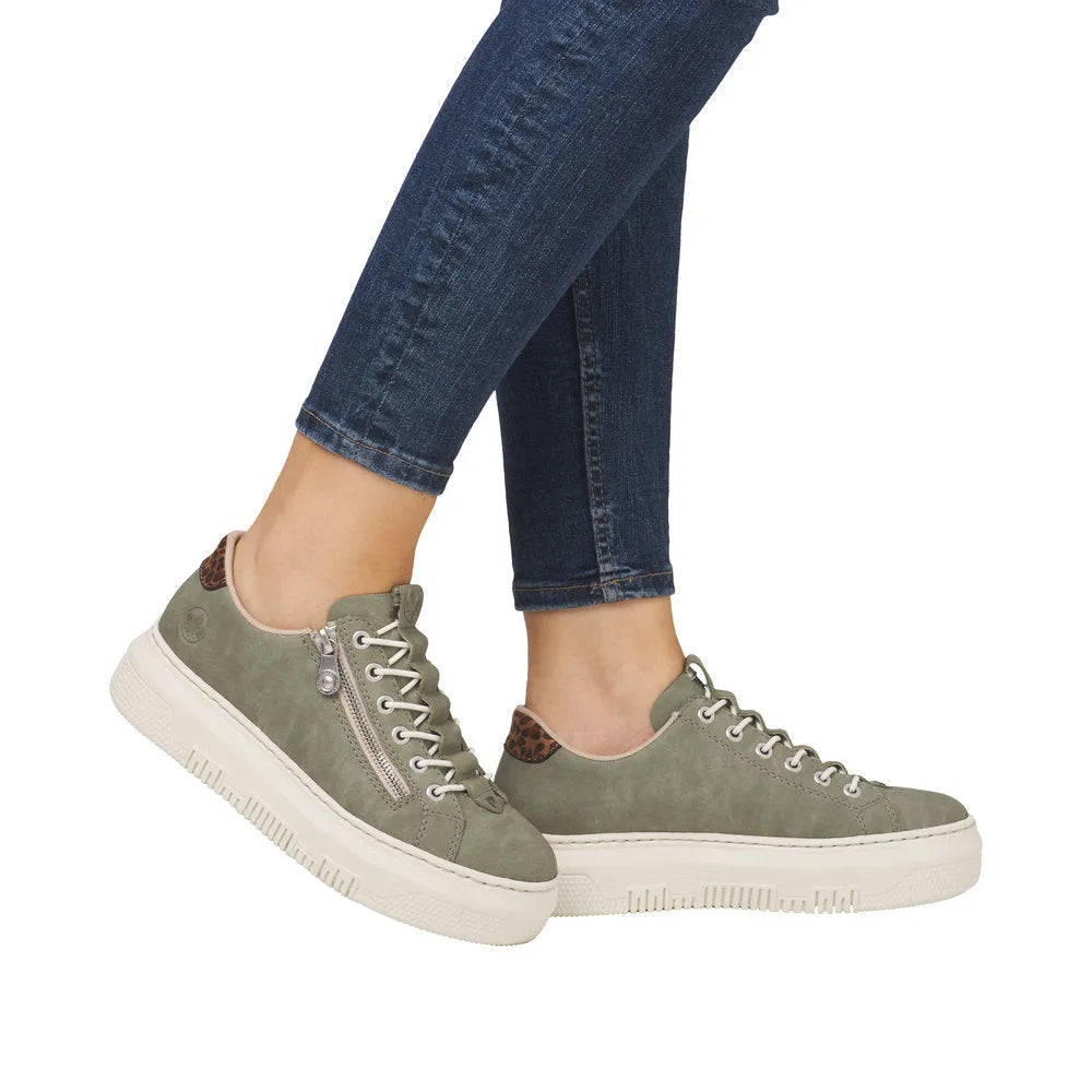 Rieker M1952-52 women's green casual sneakers with lace-up and zipper detail, leopard print accents, and thick white sole.