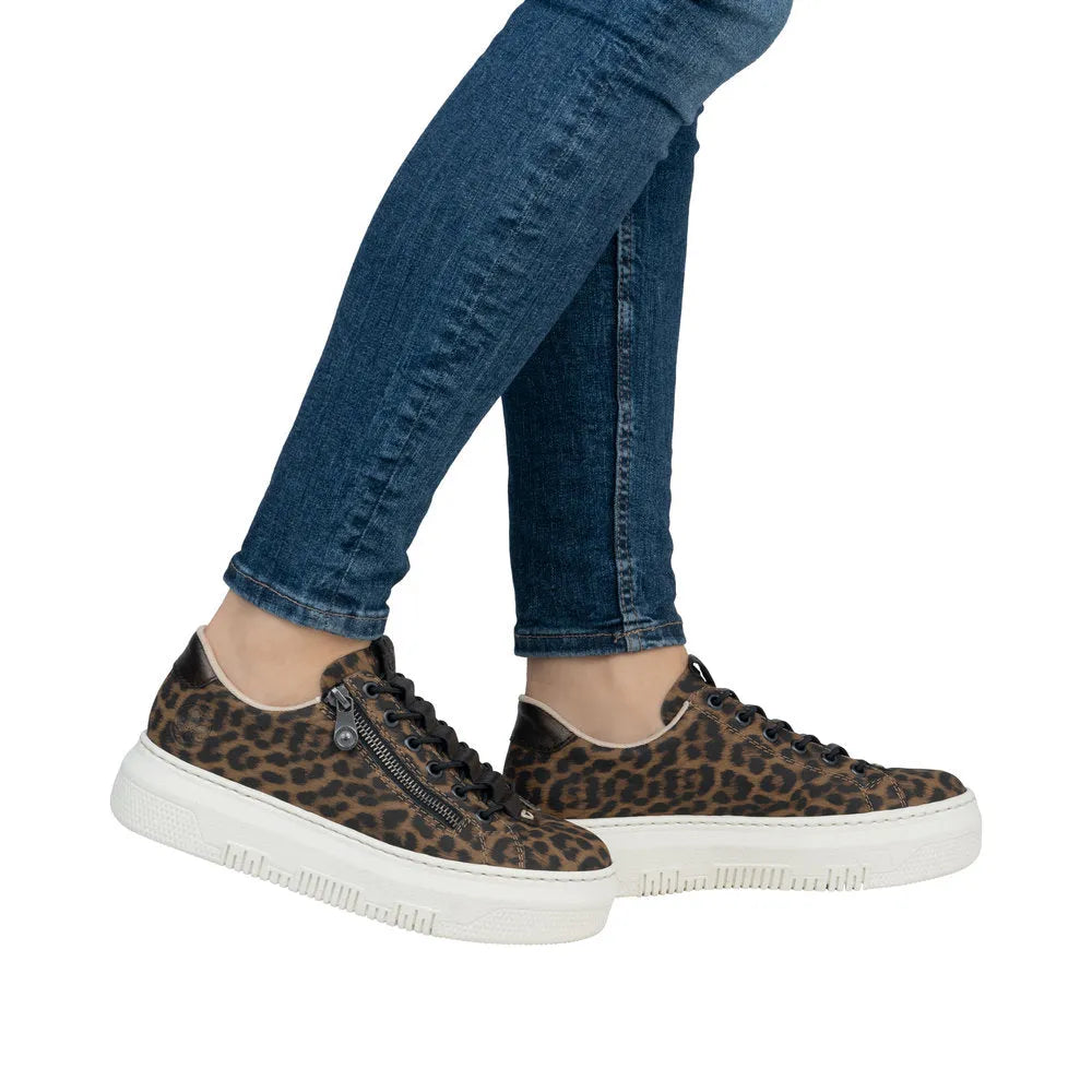 Rieker M1953-90 women's animal print lace-up sneakers with zip detail, black and brown leopard pattern, and white sole.