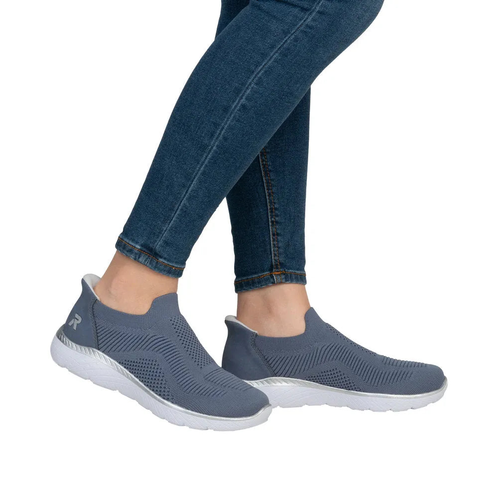 Rieker M5072-10 ladies wide-fit textile slip-on trainers in blue with white soles, casual and comfortable footwear.