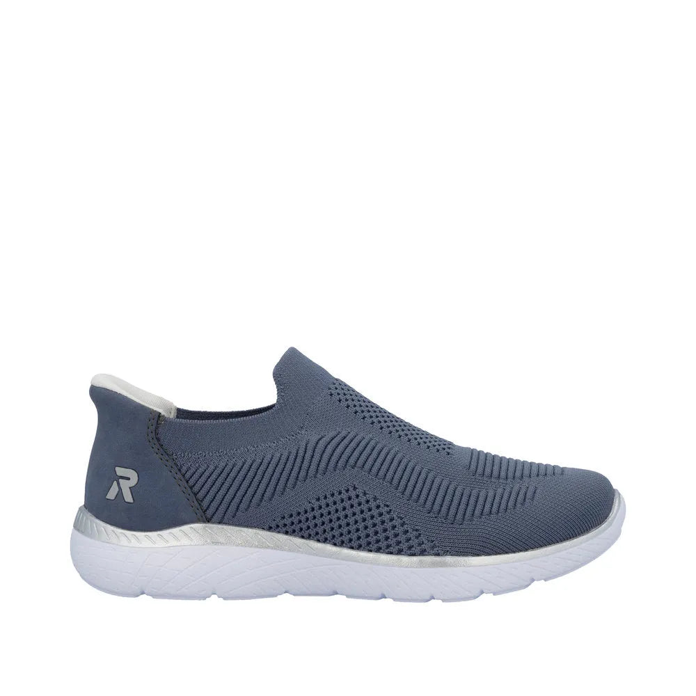 Rieker M5072-10 ladies' wide-fit slip-on trainers with textile upper, navy color, and white sole. Comfortable, casual footwear.