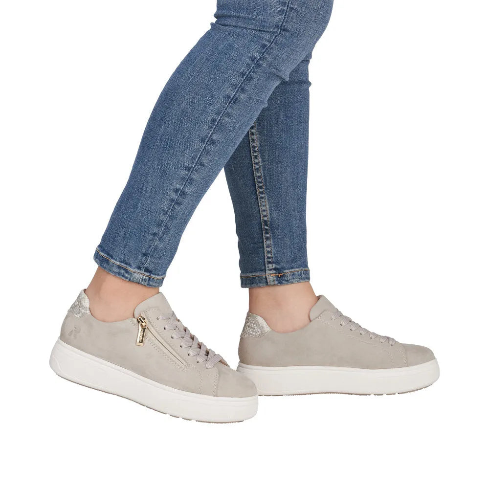 Rieker M7701-60 ladies off-white suede sneakers with lace-up and side zipper details, chunky white sole.