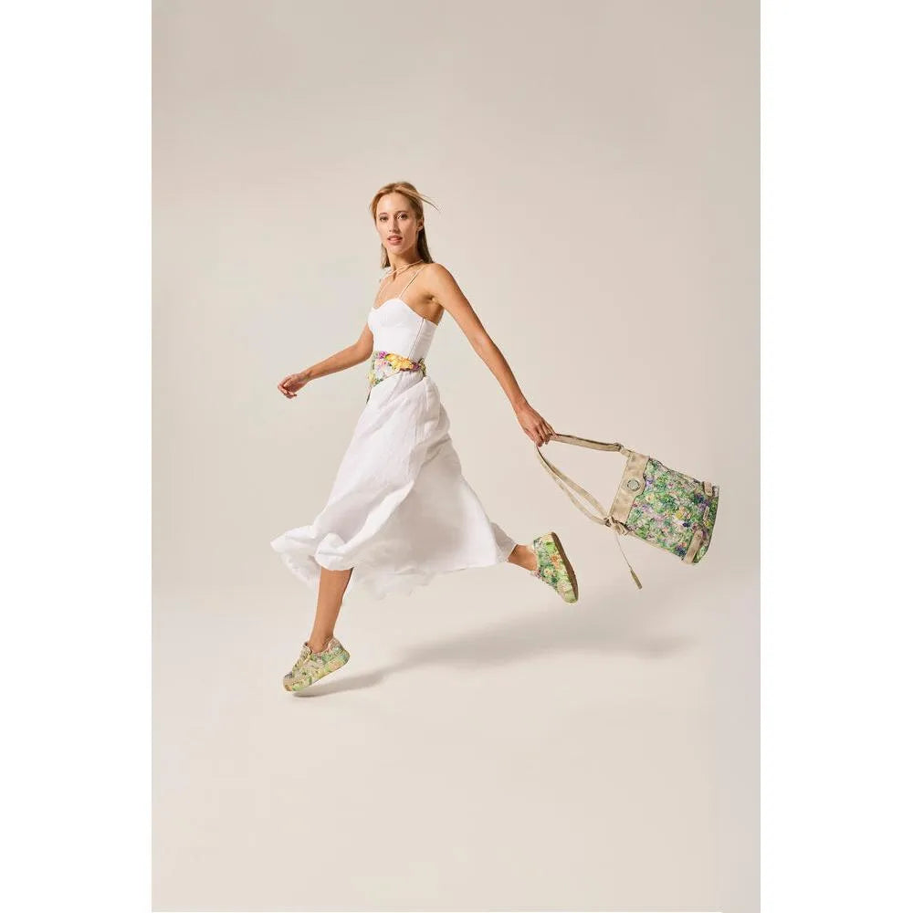 Rieker M7711-91 ladies multi-colored trainers with lace-up design, side zipper, and floral pattern, paired with a white dress and floral accessories.
