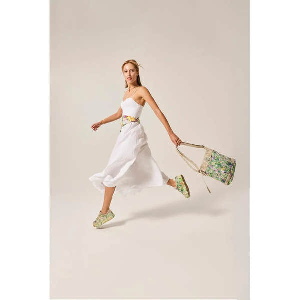 Rieker M7711-91 ladies multi-colored trainers with lace-up design, side zipper, and floral pattern, paired with a white dress and floral accessories.