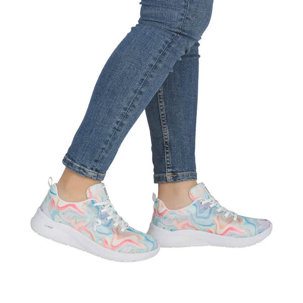Rieker M8500-90 ladies multi-colored, vegan lace-up trainers with textile upper and white sole, styled with blue jeans.