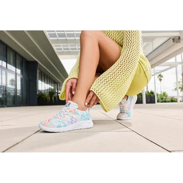 Women's pastel floral print vegan lace-up trainers with textile upper, white midsole, and sporty style.