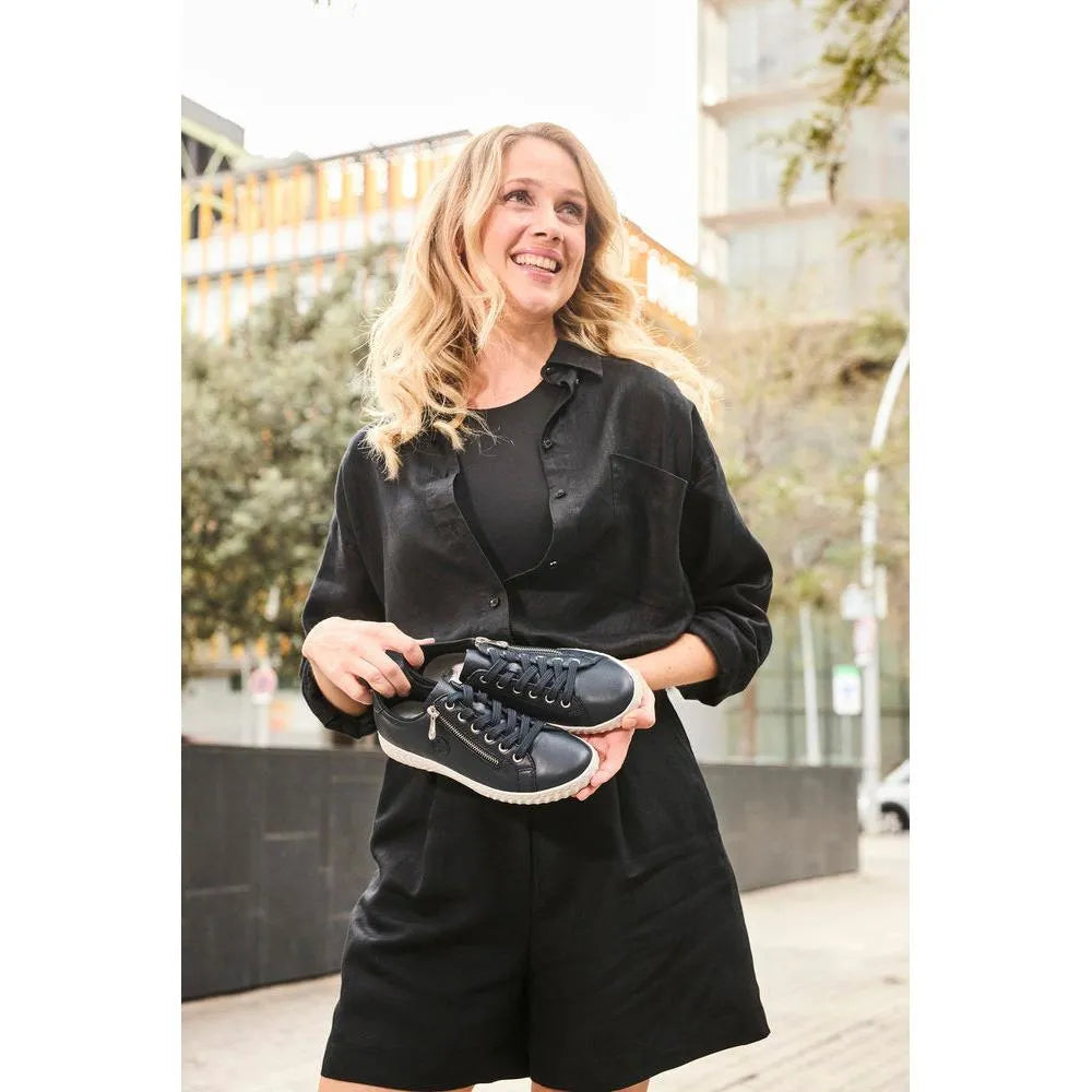 Rieker N0900-14 women's black leather zip and lace casual shoes, sporty design, outsole detail, urban outdoor setting.