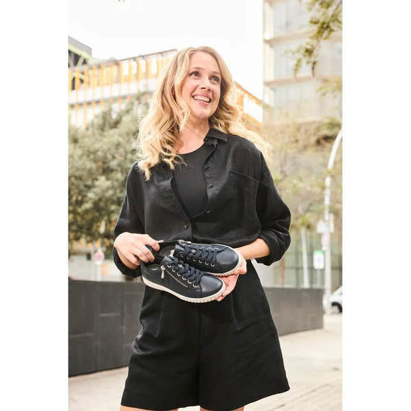 Rieker N0900-14 women's black leather zip and lace casual shoes, sporty design, outsole detail, urban outdoor setting.