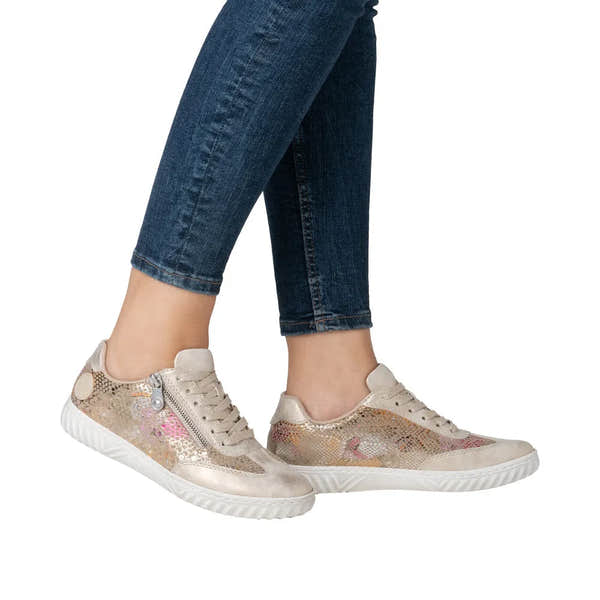 Rieker N0902-90 ladies multi-zip and lace sneakers with metallic and sequin detailing, white soles, and beige accents.