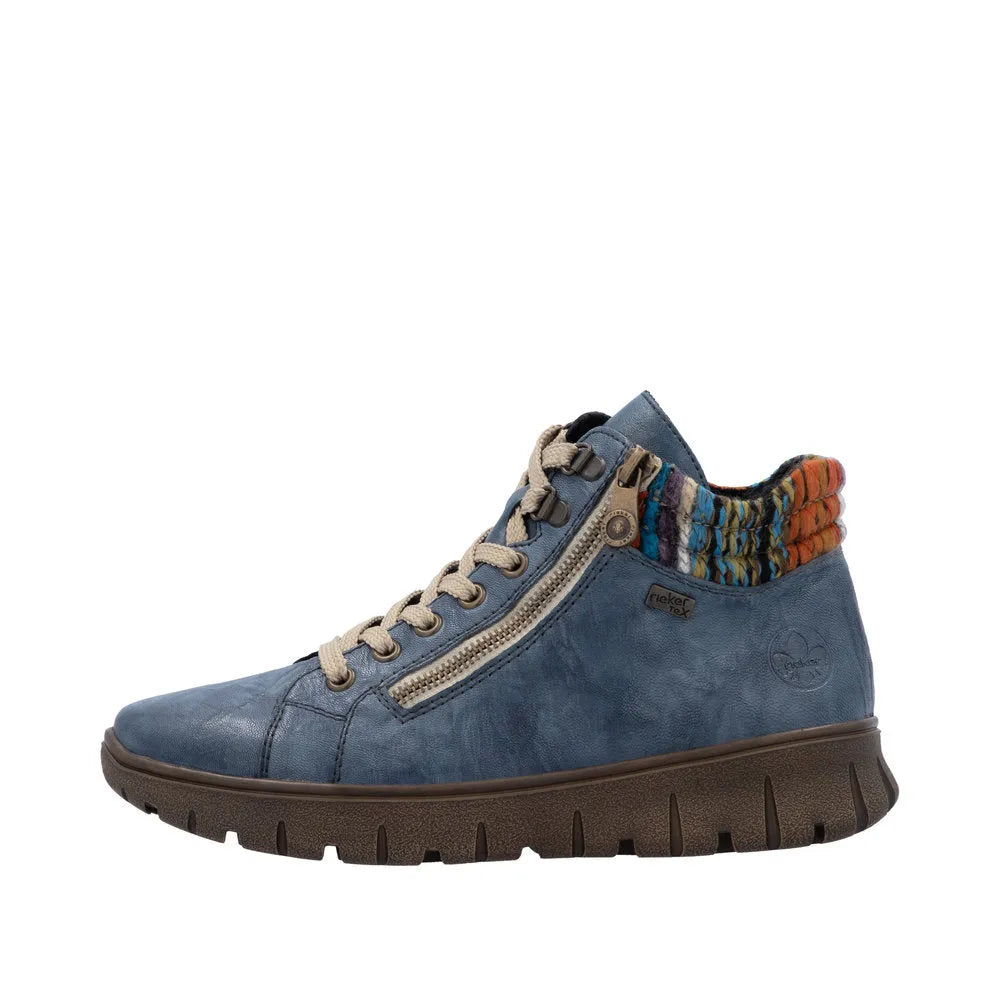Rieker N1305-14 women's blue leather ankle boots with zip and lace-up, colorful knit collar, chunky sole, and side zipper detail.