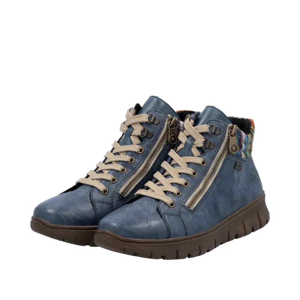 Rieker N1305-14 women's blue leather ankle boots with zip and lace-up design, cushioned sole, and colorful fabric collar detail.