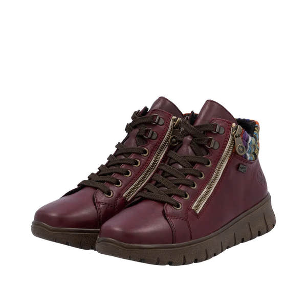 Rieker N1305-35 women's red leather ankle boots with zipper, lace-up front, and colorful interior lining.