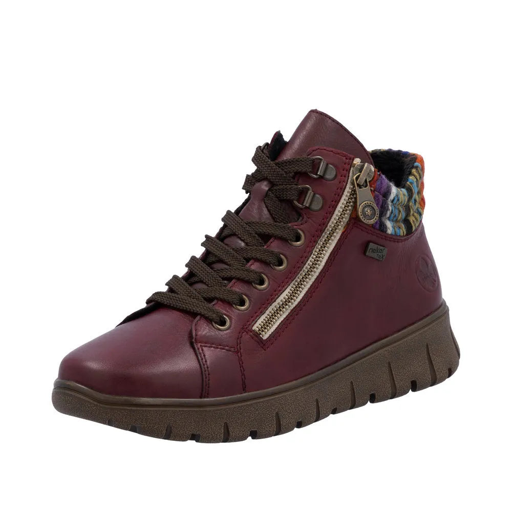 Rieker N1305-35 women's red leather ankle boots with zip and lace-up closure, side zipper, decorative multicolor knit collar, and rugged sole.