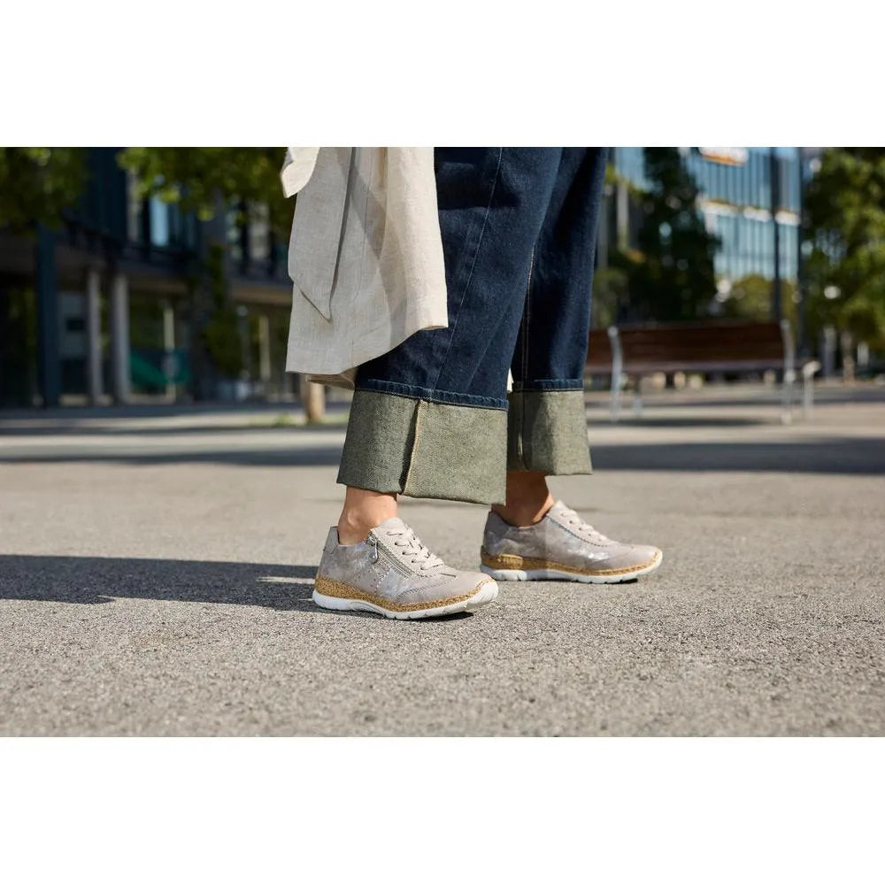 Rieker N4221-90 ladies rose-metallic zip and lace sneakers, featuring shiny material, white laces, and a cushioned sole.