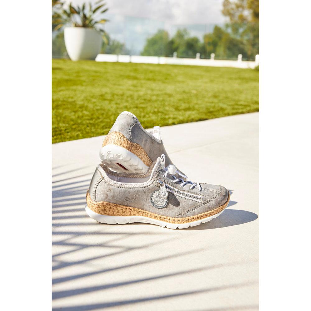 Rieker N4263-40 ladies grey/silver elasticated sports shoes with cork accents, outdoor setting, sunny day.