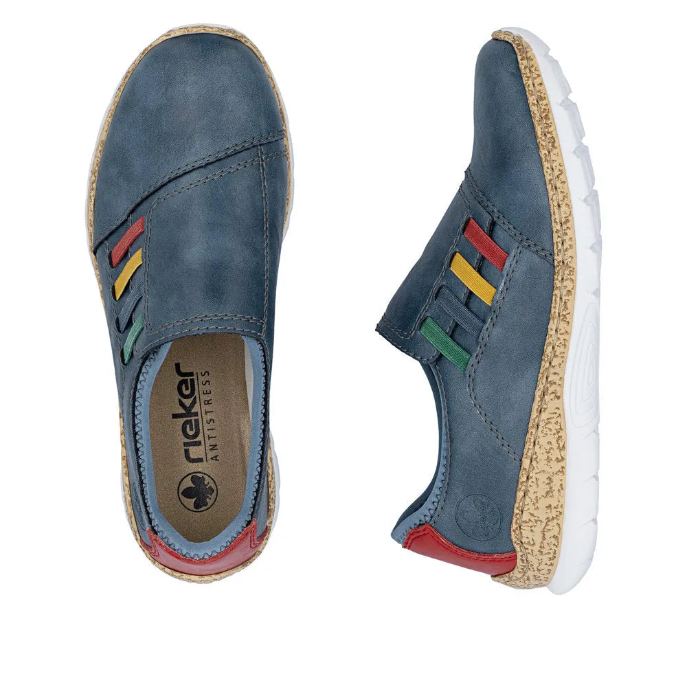 Blue elasticated women's shoes with multicolored detail, beige textured sole, and red heel tab.