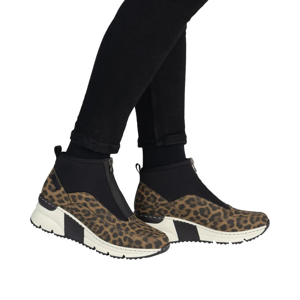 Rieker N6352-90 women's multi-front zip ankle boots with leopard print accents and sporty white sole.