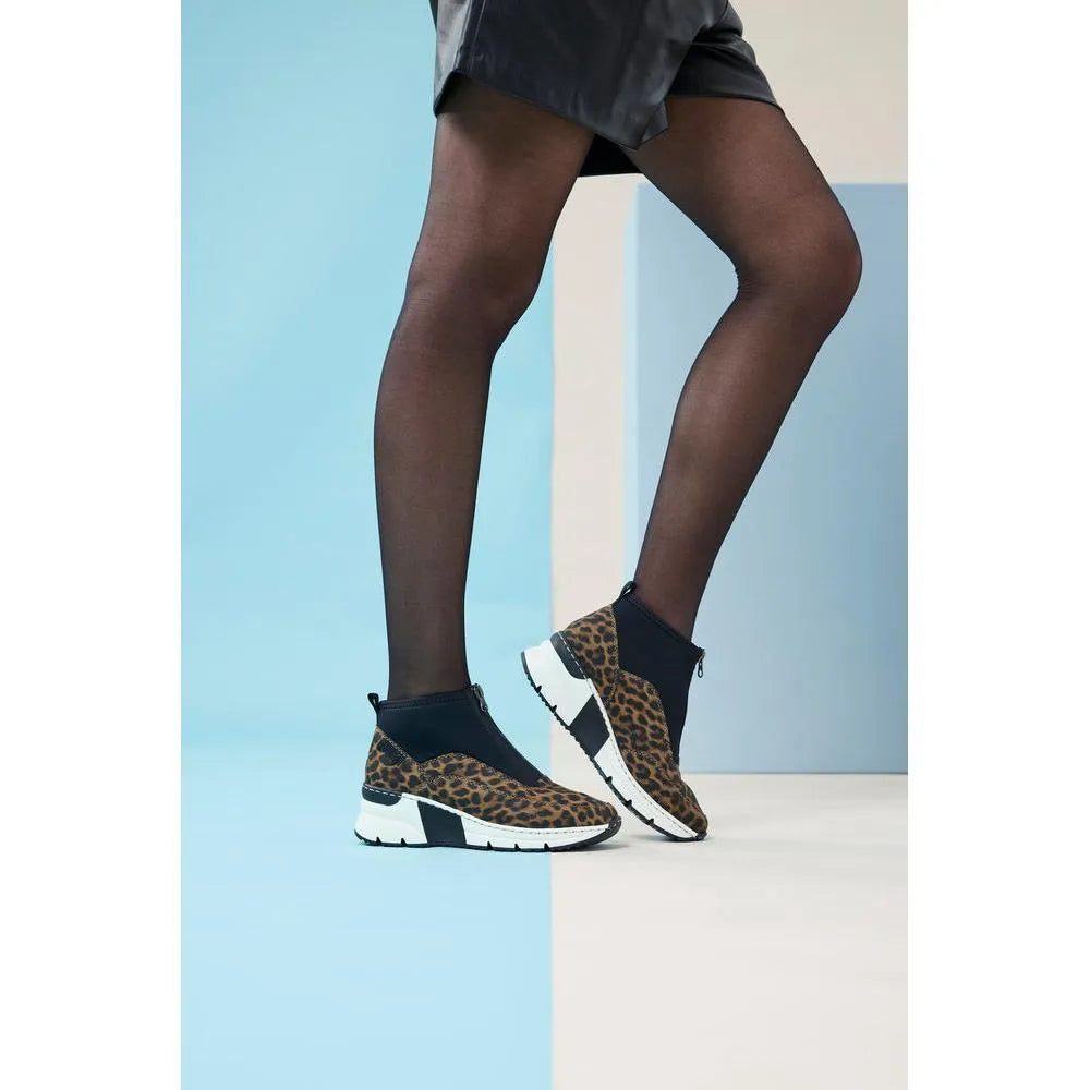 Rieker N6352-90 ladies' multi-front zip ankle boots with leopard print, black accents, and chunky white soles, stylish and comfortable.