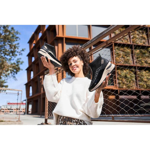 Women’s black and beige Rieker N9362-00 ankle boots with textile front, zip closure, chunky sole, fashionable design.
