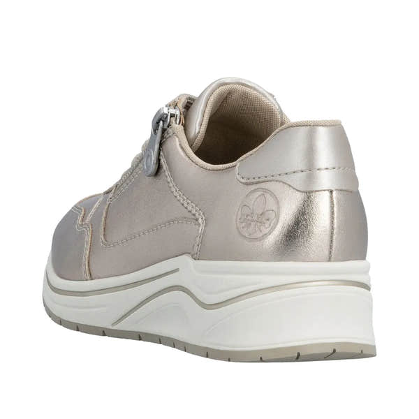 Rieker N9501-90 women's wide champagne leather sneaker with zip, lace-up, chunky white sole, and metallic finish on heel.