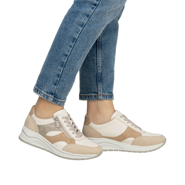 Rieker N9518-60 women's wide fit multi-zip and lace trainers in beige, cream, and gray with sporty design and chunky sole.