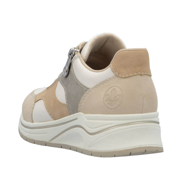 Rieker N9518-60 ladies wide-fit multi-zip and lace trainers in beige, cream, and grey with chunky sole and embossed logo detail.