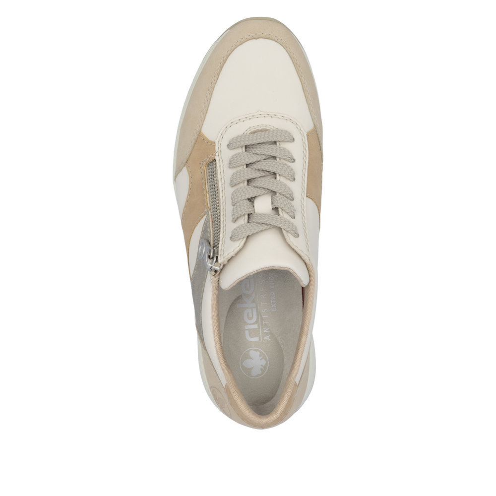 Rieker N9518-60 ladies wide-fit zip and lace trainers in beige and white with multi-zip design and cushioned sole.