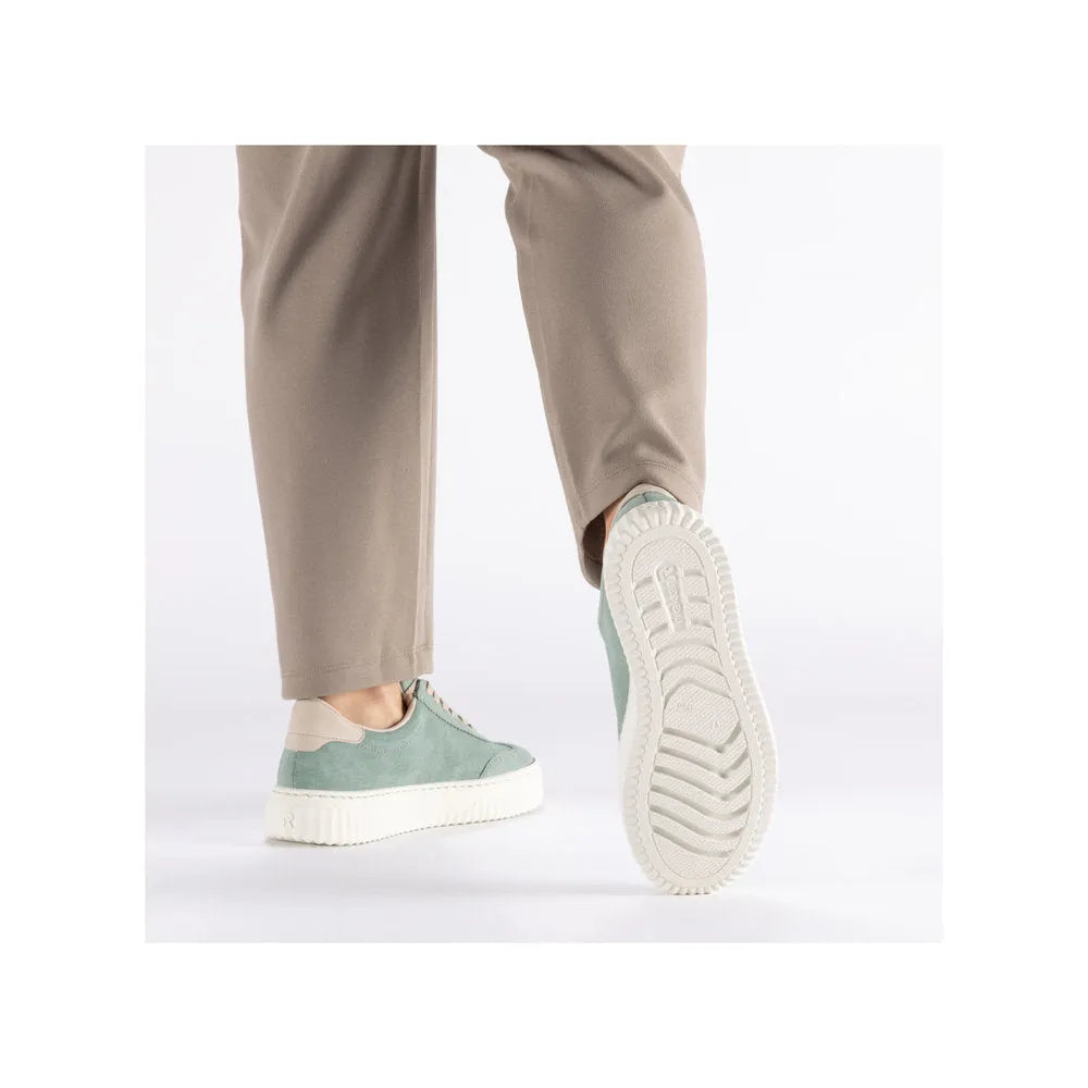 Rieker N9910-52 mint suede lace-up trainers with white chunky sole, styled with beige pants.
