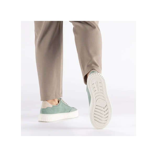 Rieker N9910-52 mint suede lace-up trainers with white chunky sole, styled with beige pants.