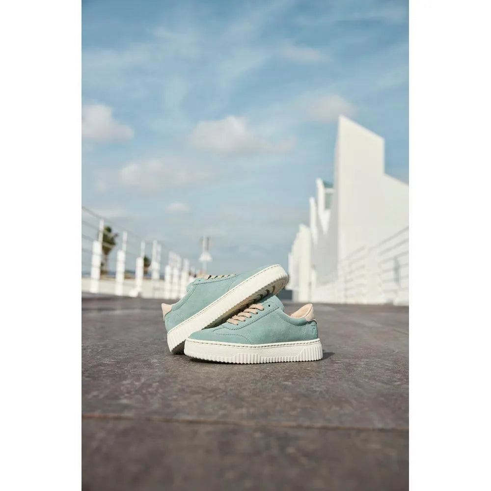 Rieker N9910-52 Ladies mint suede lace-up trainers on a rooftop with blue sky and modern white buildings in the background.