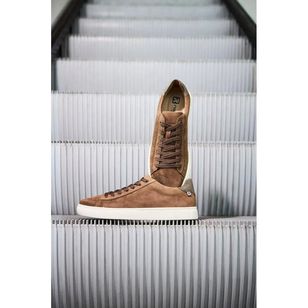 Brown suede lace-up men's shoes with white sole, high-top style, on white escalator steps.