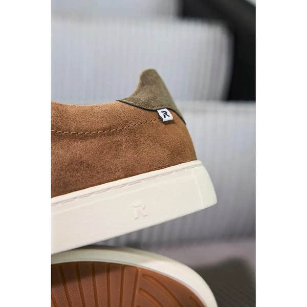 Brown suede lace-up men's shoes with white rubber soles, slight heel, and small Rieker logo tag detail.