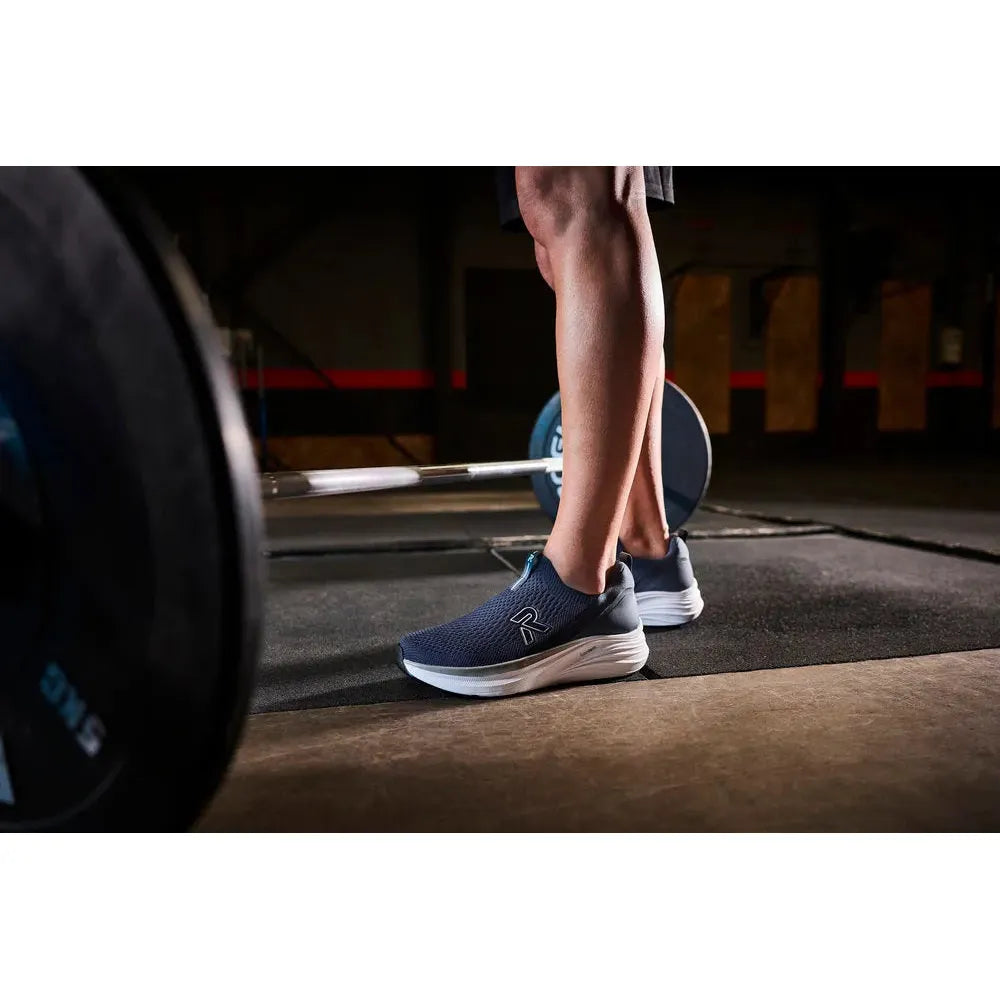 Rieker U4100-14 men's wide-fit blue textile slip-on shoes in a gym setting, showcasing sporty comfort and casual style.