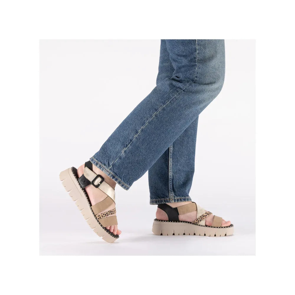 Rieker V1063-90 women's multi-touch fastening sandals with chunky sole and animal print accents, paired with blue jeans.