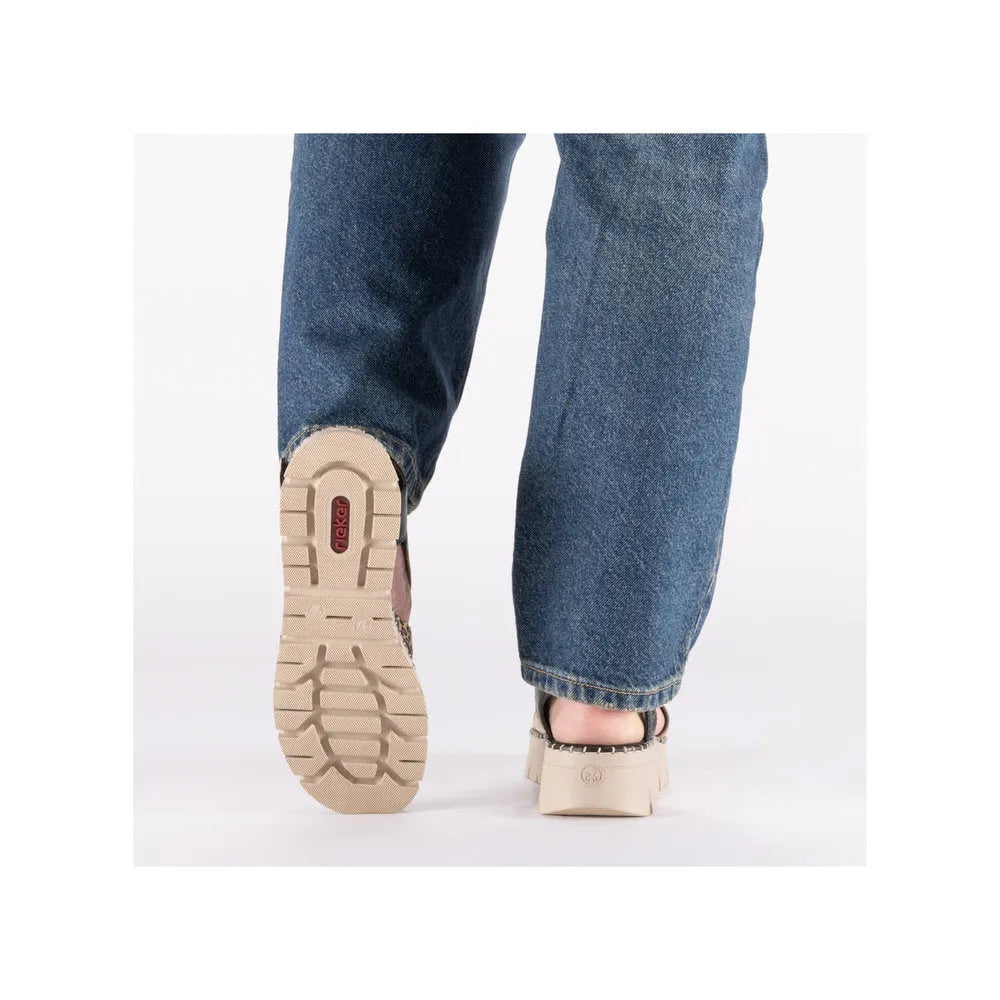 Rieker V1063-90 women's multi-touch fastening sandals with chunky heels and beige soles, shown from the back with denim jeans.