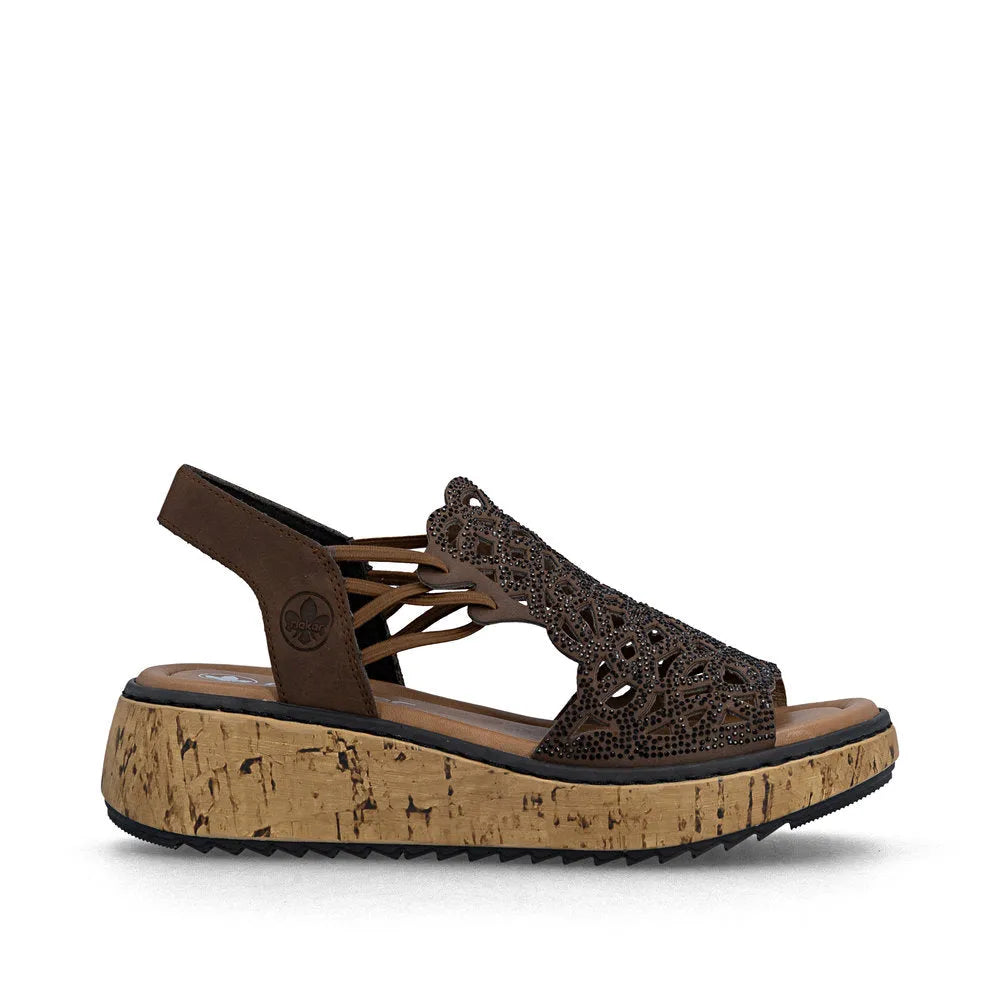 Rieker V1765-24 women's wide-fit brown elasticated platform sandal with intricate cutout design and cork sole.