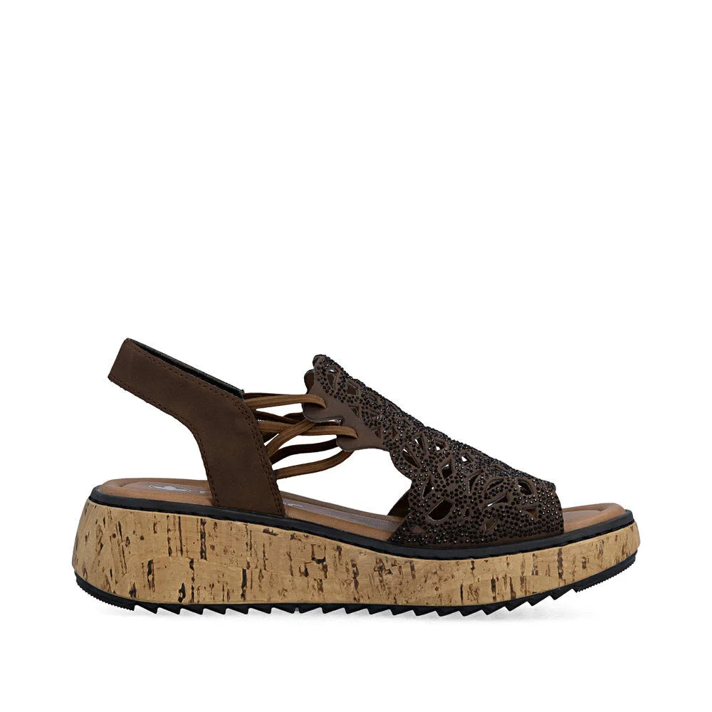 Rieker V1765-24 women's wide fit brown elasticated sandal with laser-cut design and cork wedge sole.