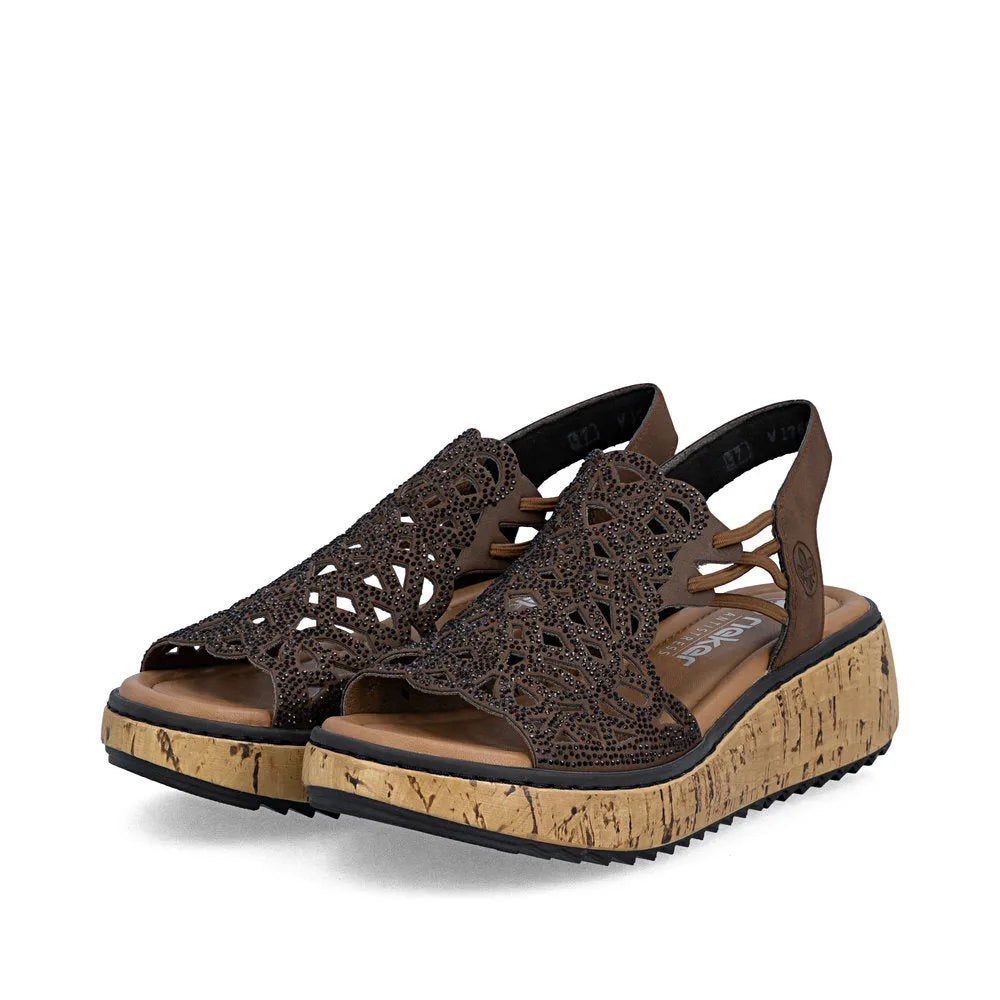 Rieker V1765-24 women's wide-fit brown elasticated open-toe sandals with decorative cut-out design and cork-effect platform sole.