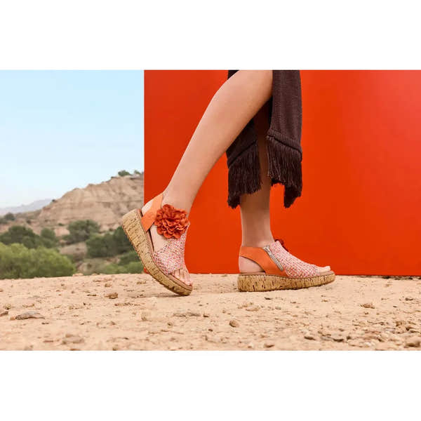 Rieker V1783-90 women's pumpkin orange textile side zip sandals with floral decoration and cork wedge sole.